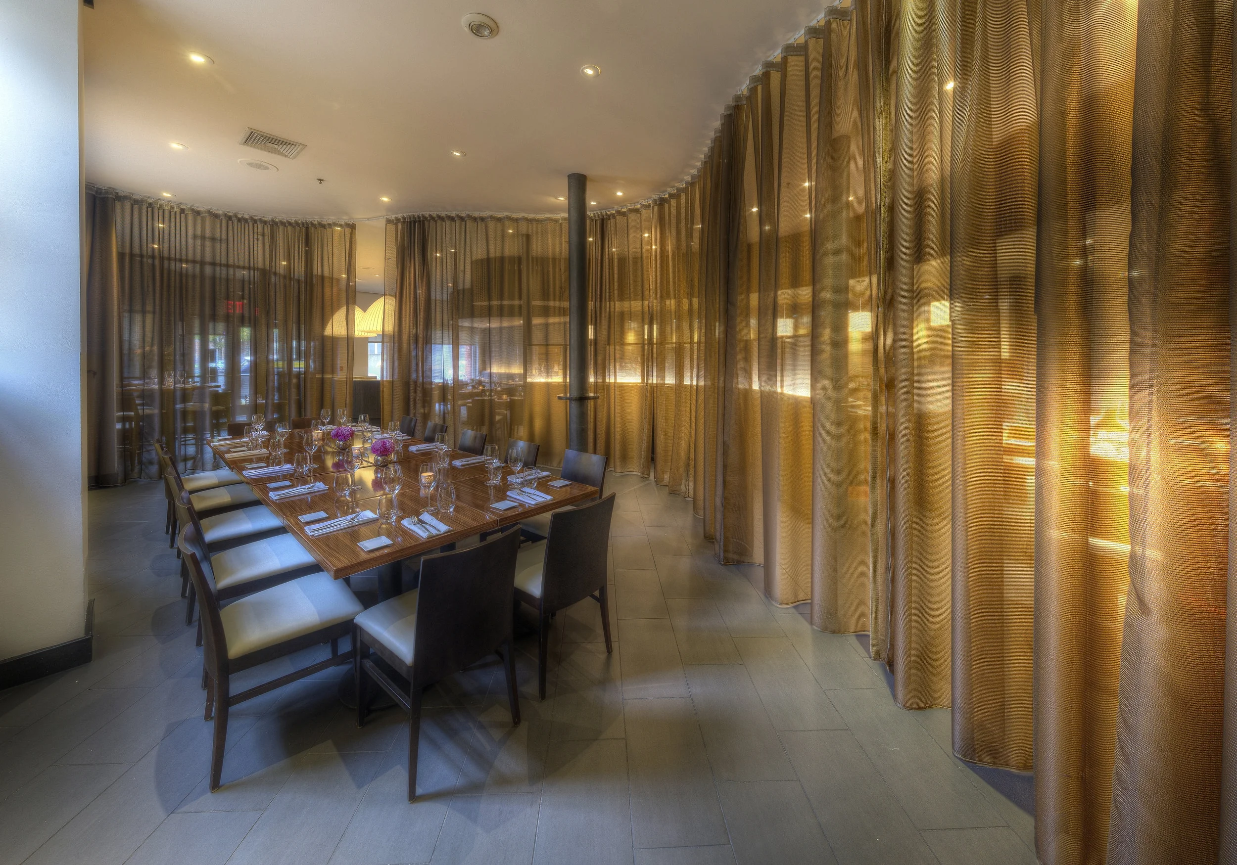 Part of the restaurant enclosed by a shimmering curtain at olea