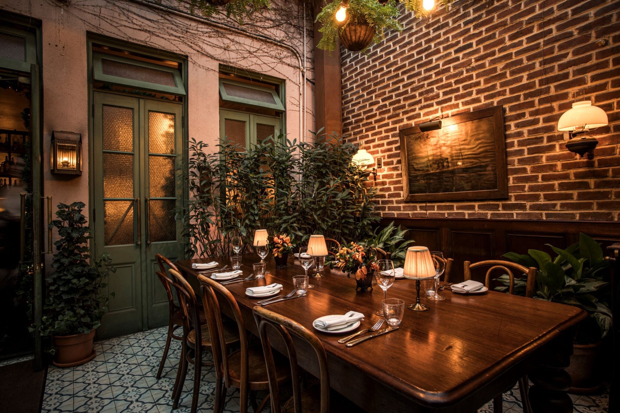 Greenhouse dining table (enclosed rear garden patio) at Maison Premiere
